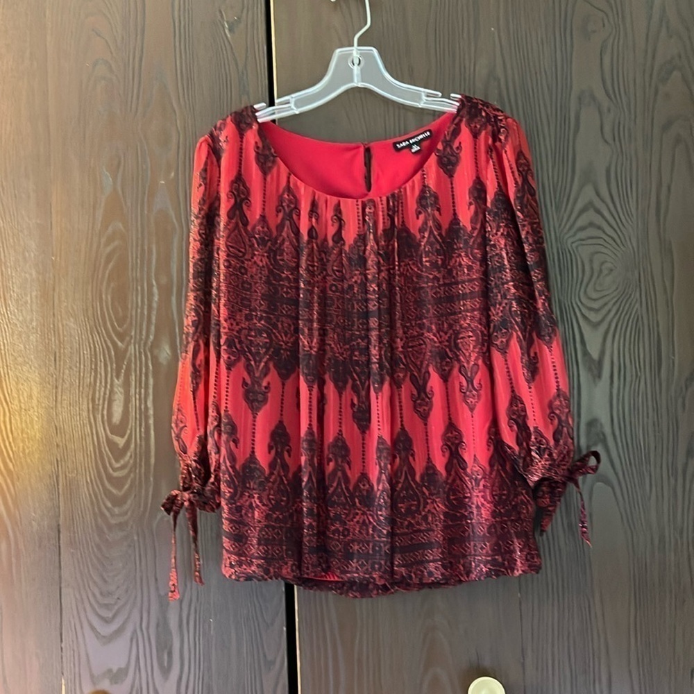 Sara Michelle 3/4 sleeved red blouse with black design. Size Medium.